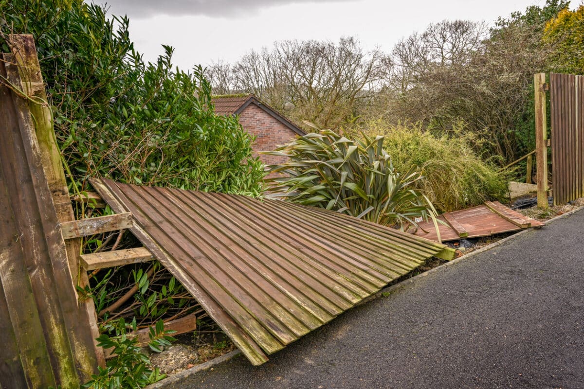 Wooden fence blown down by strong winds
